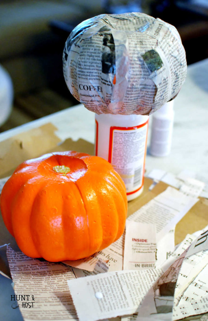Newspaper decoupage makes the most gorgeous black and white pumpkins. They are a cinch to DIY for your fall holiday décor.
