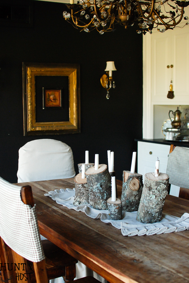 This easy DIY tutorial will show you how to take tossed firewood and turn it into a beautiful rustic winter tablescape by creating log candlesticks.
