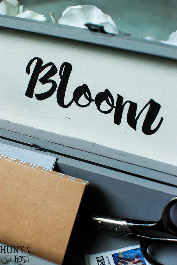 An old wine gift box transformed into a blooming storage box with dollar store flowers. PLUS five other DIY dollar store ideas with flowers. 