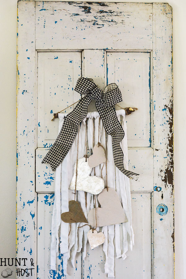 Create boho chic wall hanging decor from your old linens. Purging the linen closet will provide tons of great crafting material. This DIY wall hanging is dressed up for Valentine's Day, but would be great for a farmhouse feel any time of year. WIth great texture from burlap, drop cloth and tin foil this tone on tone neutral decor is a versatile addition to any style, Simple natural touches round out this Valentine home tour. 
