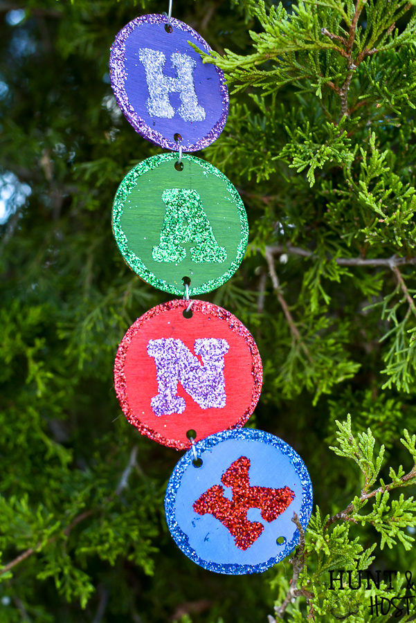 Make your own personalized Christmas ornament with your name, your kid's name or just fun Christmas sayings and words. This easy DIY takes no special tools or machines. You can make custom christmas ornaments to fit your color scheme and any name, even a christmas ornament for unusual names! Everyone loves to see their name in glitter and on the Christmas tree so make these special ornaments for the whole family. #handmadechristmas #christmastreeornaments #decoratethetree #nameinlights #DIYChristmasornament #glitter #easy #simpleChristmas