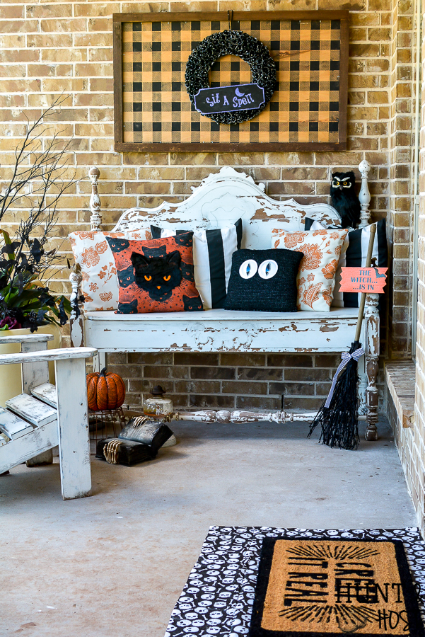 5 ideas to update your Halloween decorations to keep them trendy. Add easy personal touches to your Halloween decorating ideas to keep them current and fun! So many examples in this cute Halloween porch scene. #handmadewithjoann #halloweenporch #halloweenideas #layereddoormat #diysign #glowinthedark
