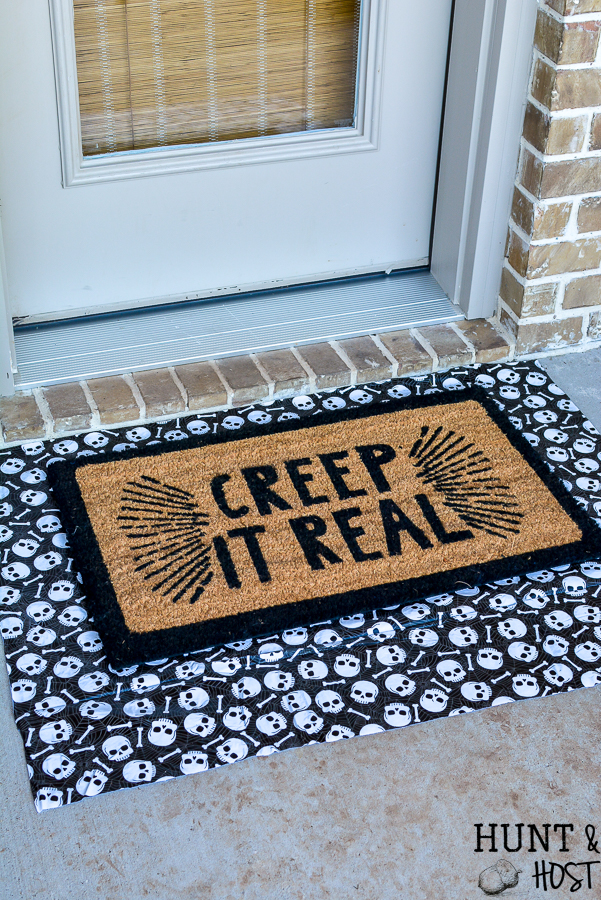 5 ideas to update your Halloween decorations to keep them trendy. Add easy personal touches to your Halloween decorating ideas to keep them current and fun! So many examples in this cute Halloween porch scene. #handmadewithjoann #halloweenporch #halloweenideas #layereddoormat #diysign #glowinthedark